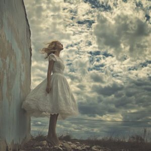 woman in white dress stang in front of white clouds