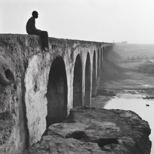 photojounalism showing man sitting on abandoned bridge